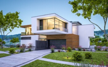 3d rendering of modern cozy house by the river with garage for sale or rent with beautiful mountains on background. Clear summer evening with blue sky. Cozy warm light from window.